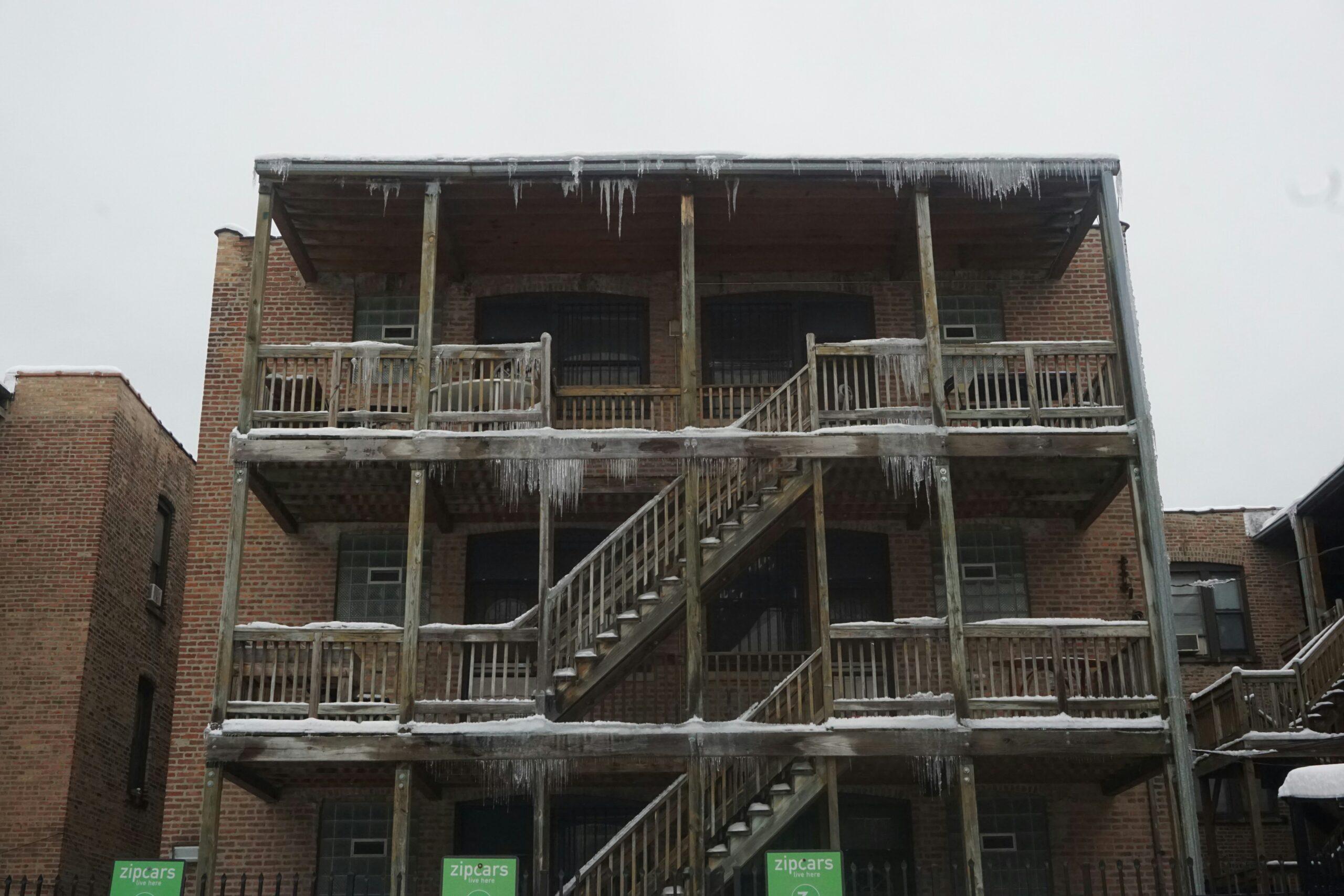 Ice covers the stairs of a building, creating a slippery hazard during the winter season.