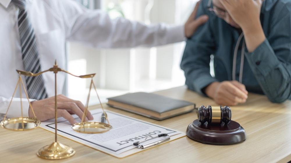 Prosecutor or lawyer comforts a client who is worried
